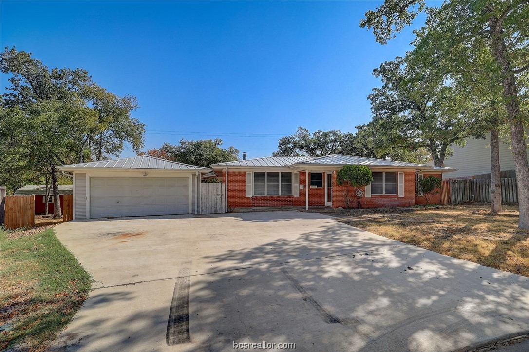 3805 Oaklawn Street Bryan, TX 77801 - Photo 1 of 1 a front view of a house with a garden