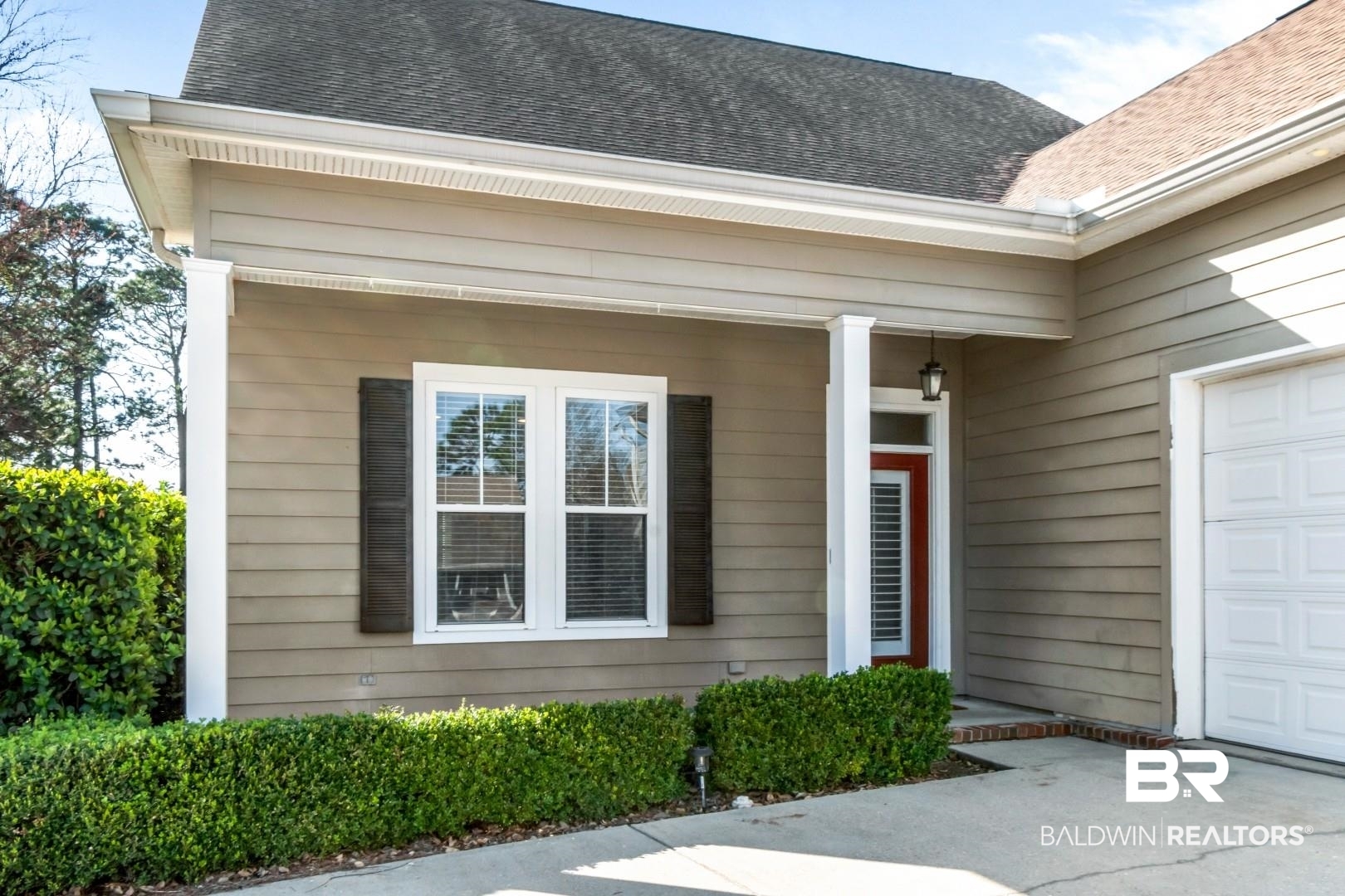 30585 Pine Court Daphne, AL 36527 - Photo 24 of 49 Doorway to property with roof with shingles, an attached garage, concrete driveway, and a porch