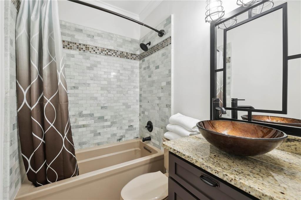 3675 Peachtree Road Northeast, Unit 45 Atlanta, GA 30319 - Photo 15 of 42 a bathroom with a granite countertop sink and a mirror