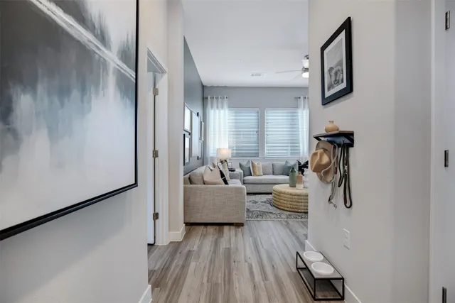 a living room with couches and painting on the wall