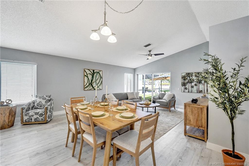 4365 Pine Ridge Court Weston, FL 33331 - Photo 13 of 63 a view of a dining room with furniture and chandelier
