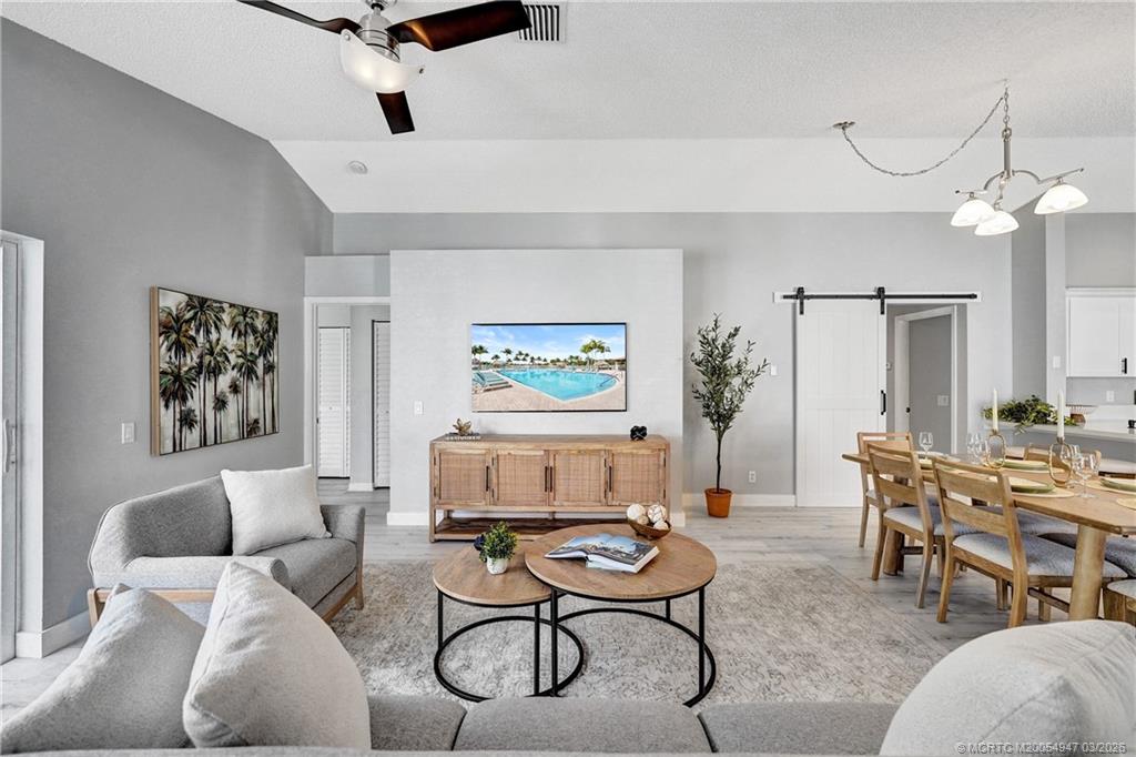 4365 Pine Ridge Court Weston, FL 33331 - Photo 23 of 63 a living room with furniture a wooden floor and a chandelier