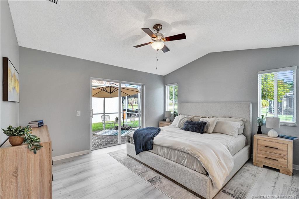 4365 Pine Ridge Court Weston, FL 33331 - Photo 27 of 63 a bedroom with a balcony a bed and a large window