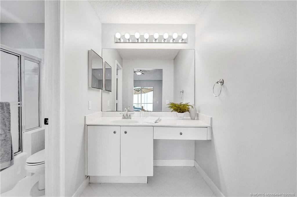 4365 Pine Ridge Court Weston, FL 33331 - Photo 31 of 63 a spacious bathroom with a toilet a sink and a mirror