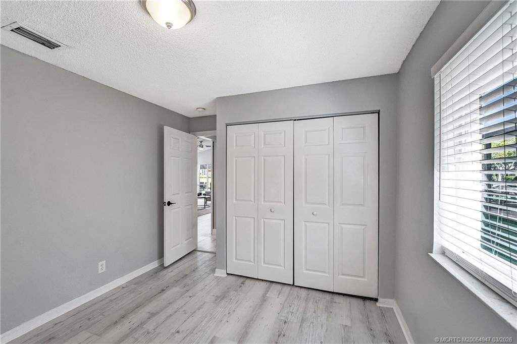 4365 Pine Ridge Court Weston, FL 33331 - Photo 33 of 63 a view of an empty room with wooden floor and a window