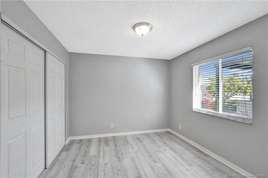 4365 Pine Ridge Court Weston, FL 33331 - Photo 34 of 63 an empty room with wooden floor and windows