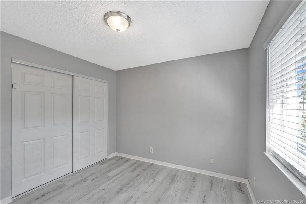 4365 Pine Ridge Court Weston, FL 33331 - Photo 35 of 63 an empty room with wooden floor and windows