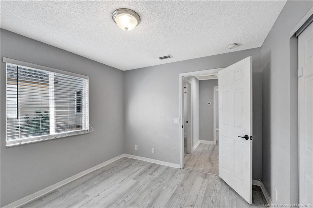 4365 Pine Ridge Court Weston, FL 33331 - Photo 36 of 63 a view of an empty room with wooden floor and a window