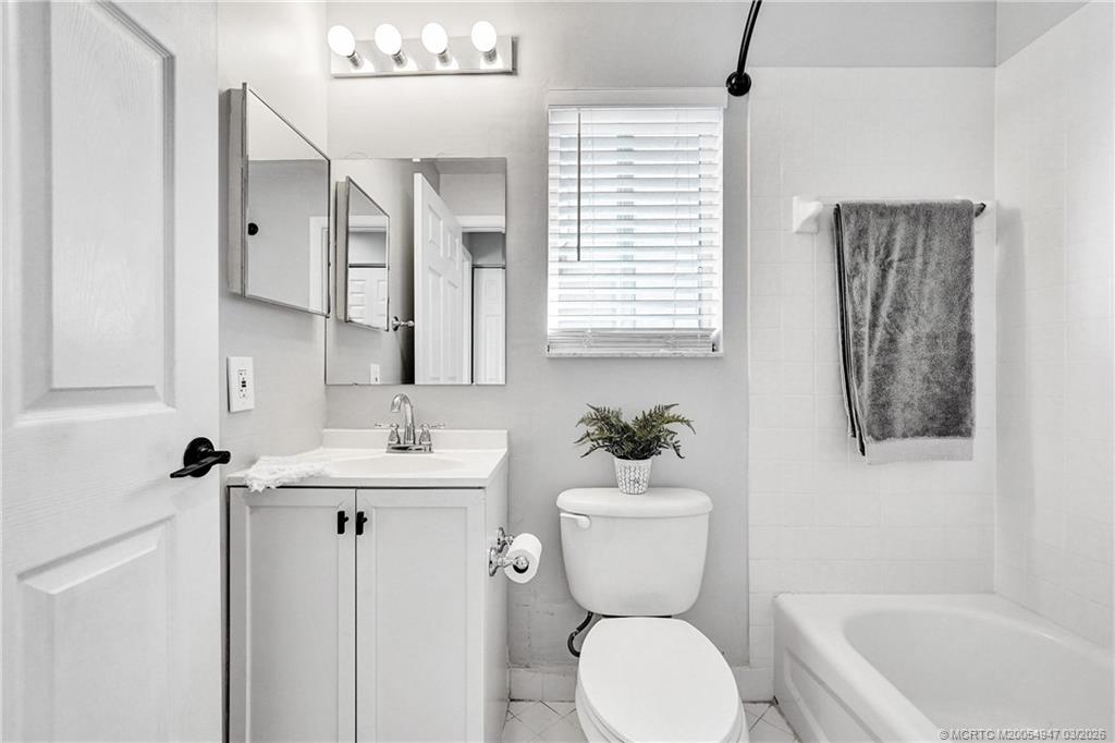 4365 Pine Ridge Court Weston, FL 33331 - Photo 38 of 63 a bathroom with a toilet sink and mirror