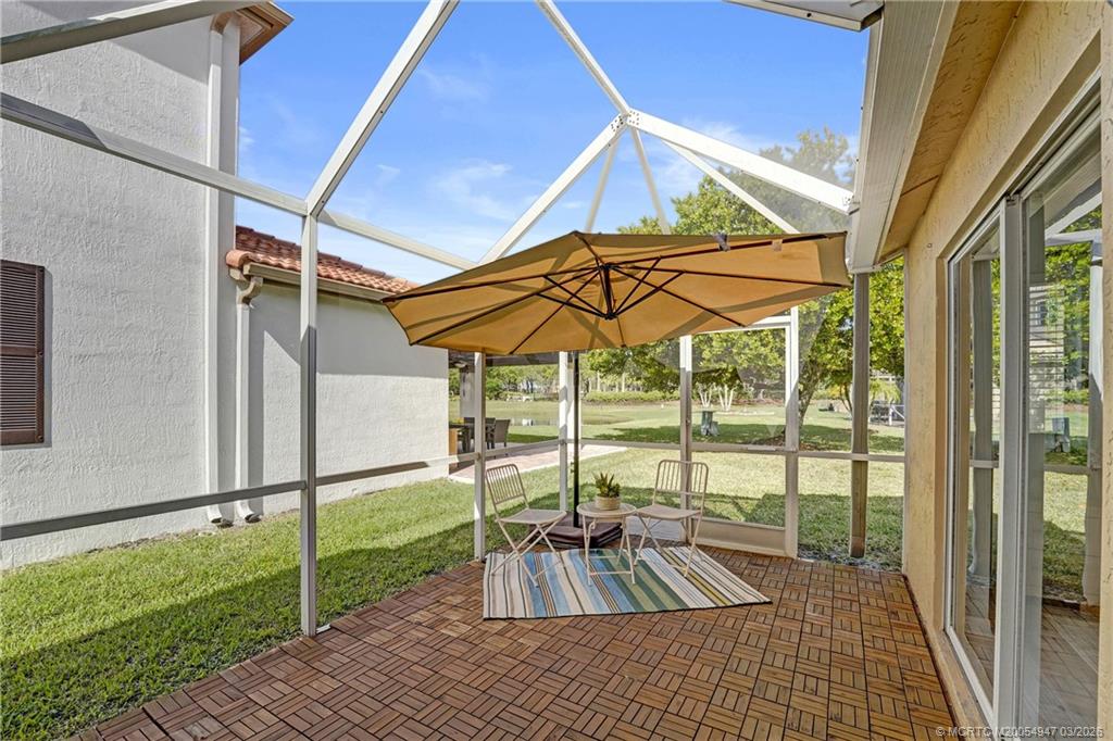 4365 Pine Ridge Court Weston, FL 33331 - Photo 40 of 63 a view of a balcony with chairs and an umbrella