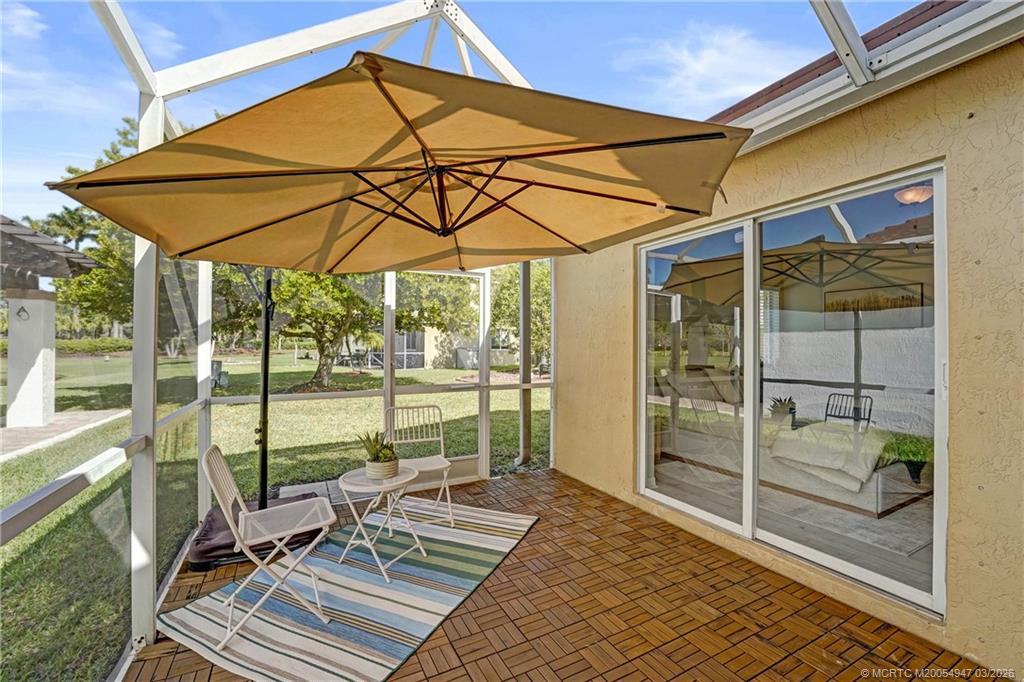 4365 Pine Ridge Court Weston, FL 33331 - Photo 42 of 63 a view of a patio with a table and chairs under an umbrella