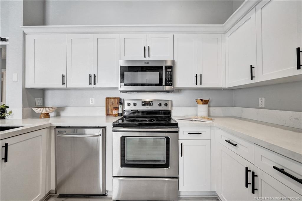 4365 Pine Ridge Court Weston, FL 33331 - Photo 8 of 63 a kitchen with cabinets stainless steel appliances and sink