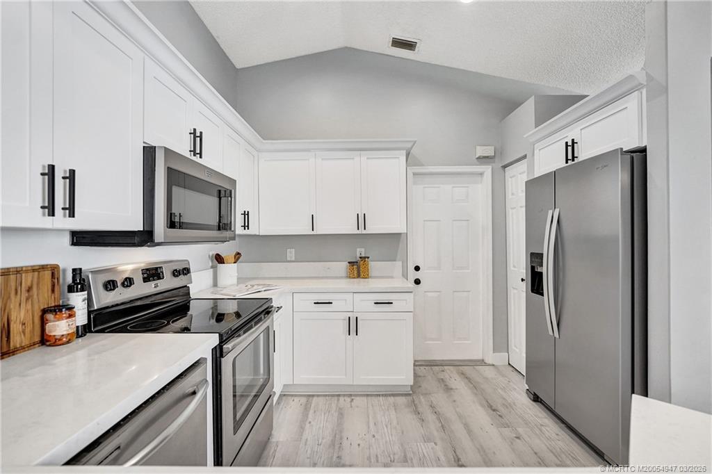 4365 Pine Ridge Court Weston, FL 33331 - Photo 9 of 63 a kitchen with stainless steel appliances a stove a sink and a refrigerator