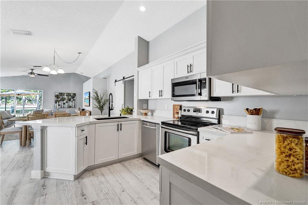 4365 Pine Ridge Court Weston, FL 33331 - Photo 10 of 63 a kitchen with granite countertop white cabinets and stainless steel appliances
