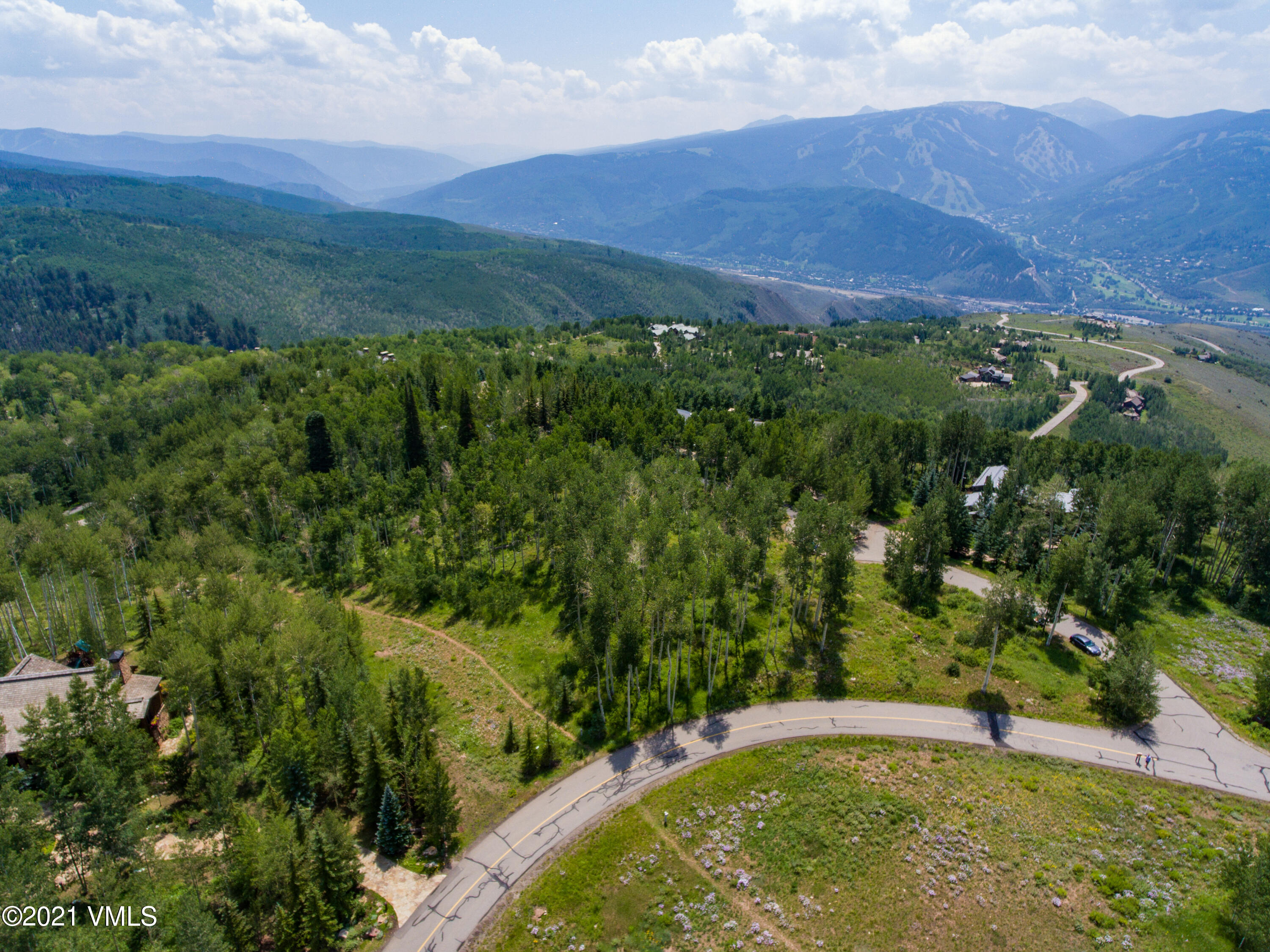 294 Shooting Star Avon, CO 81620 - Photo 4 of 23 a view of a lush green hillside and a building