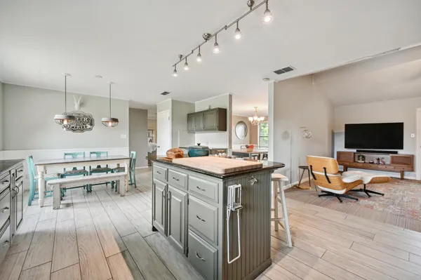 a kitchen with a stove and a wooden floor