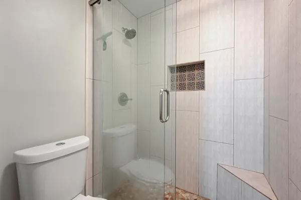a bathroom with a shower and toilet