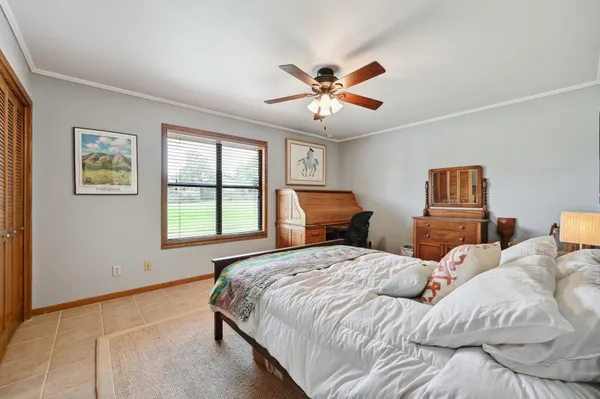 a bedroom with a large bed and a window