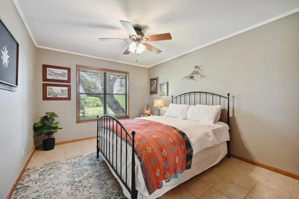 a bedroom with a large bed and a chandelier