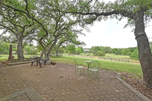 a view of a lake with a table and chairs