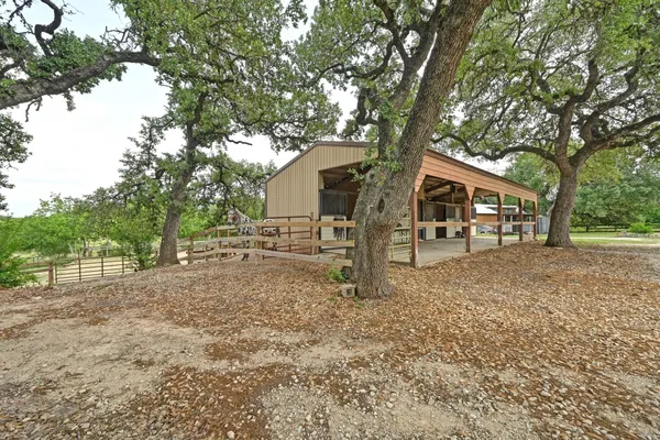 a front view of a house with a tree