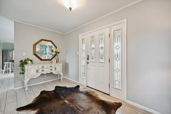 a living room with furniture and a large mirror