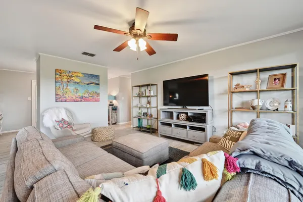 a living room with furniture and a flat screen tv