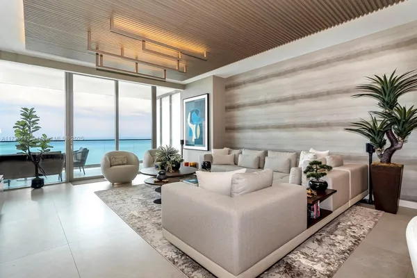 a living room with furniture and a chandelier