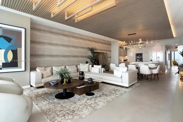 a view of a dining room with furniture and a chandelier