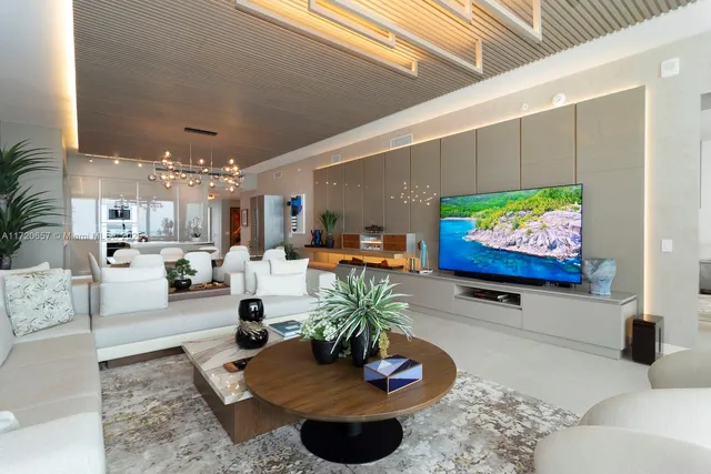 a view of a dining room with furniture and a chandelier
