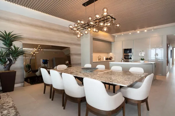 a view of a dining room with furniture and chandelier
