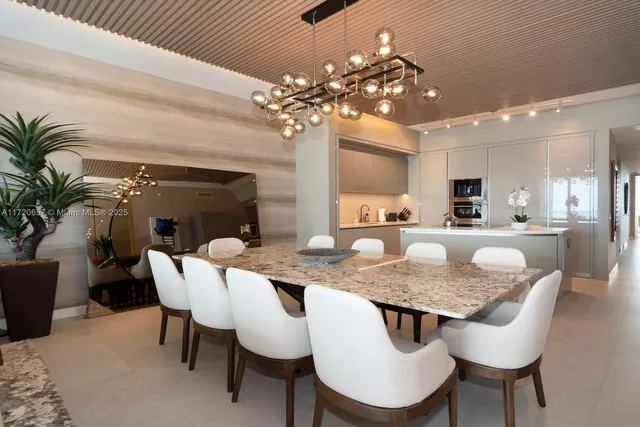 a view of a dining room with furniture and chandelier