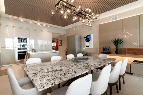 a kitchen with stainless steel appliances granite countertop a refrigerator a sink and a stove