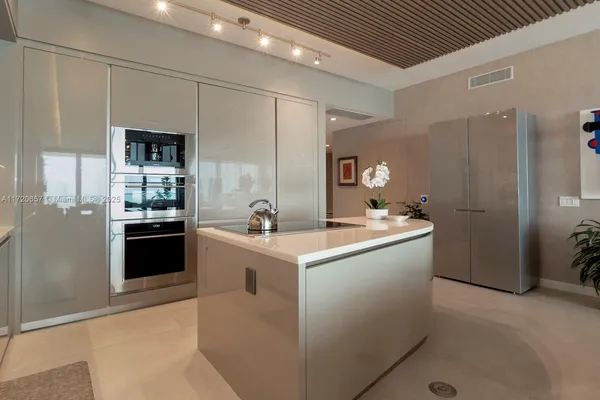 a kitchen with cabinets and stainless steel appliances
