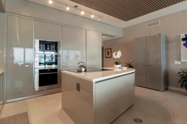 a kitchen with cabinets and stainless steel appliances