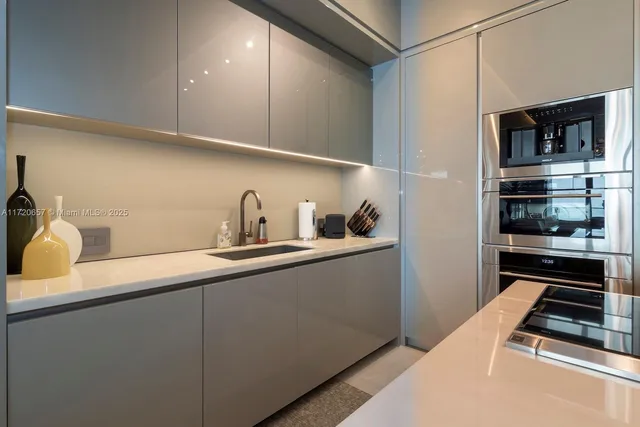 a kitchen with a table chairs stove and cabinets