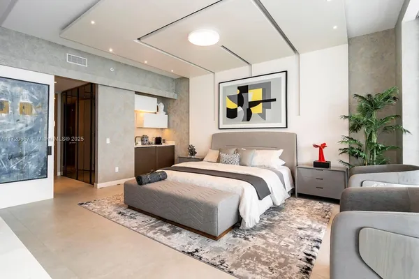 a living room with couches a flat screen tv and a potted plant