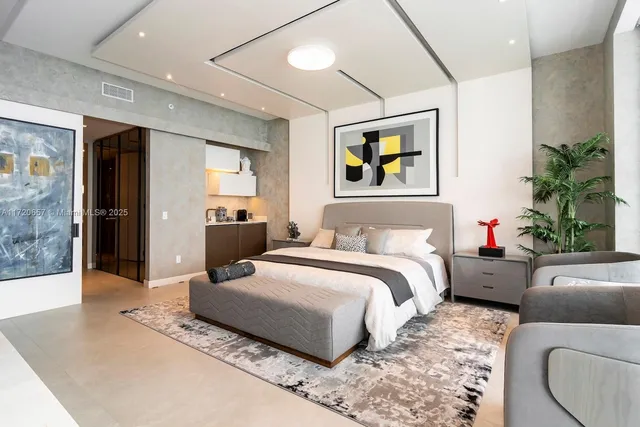 a living room with couches a flat screen tv and a potted plant