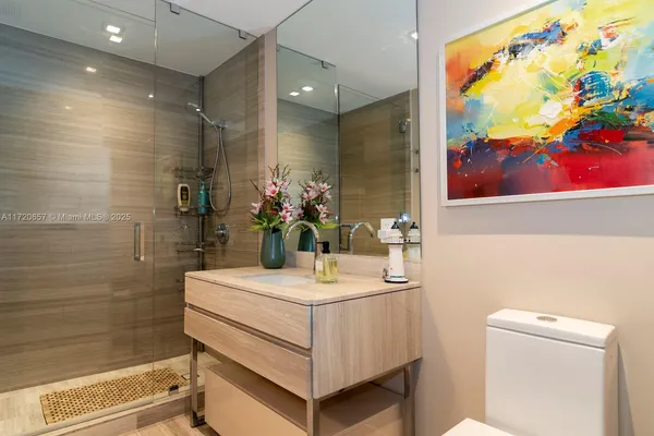 a bedroom with two large bed and a large window