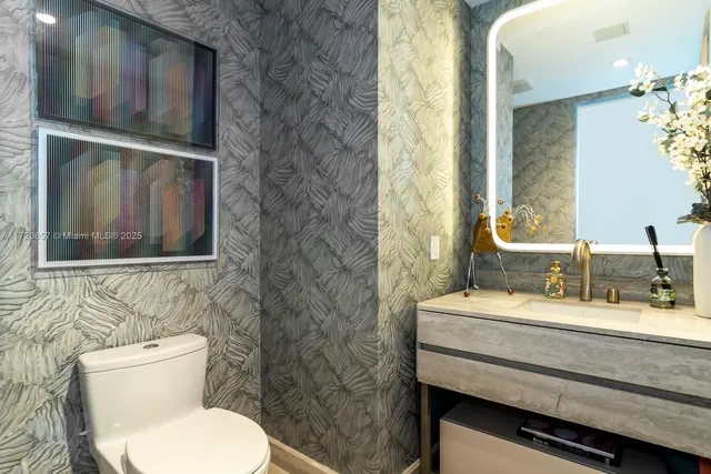 a bedroom with two bed and a flat screen tv