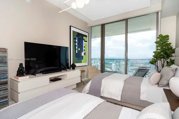 a bedroom with a bed and glass window