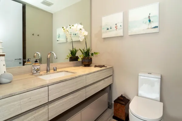 a bedroom with bed and a potted plant
