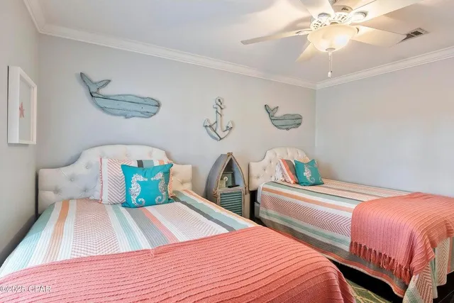 a bedroom with two beds and a chandelier