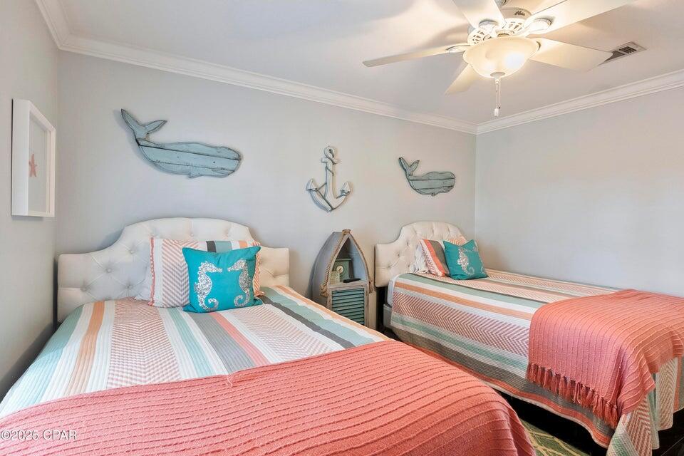 111 West Shore Place Inlet Beach, FL 32461 - Photo 13 of 45 a bedroom with two beds and a chandelier