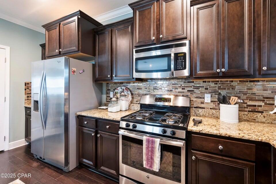 111 West Shore Place Inlet Beach, FL 32461 - Photo 27 of 45 a kitchen with granite countertop a sink stove and refrigerator