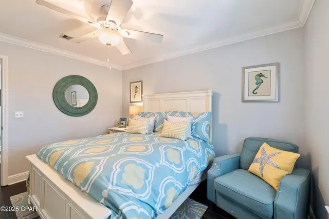 a bedroom with two beds and a chandelier