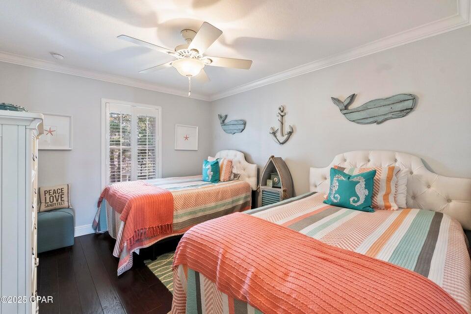111 West Shore Place Inlet Beach, FL 32461 - Photo 35 of 45 a bedroom with two beds and a chandelier