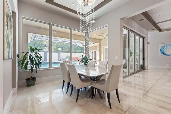 a living room with furniture and a view of kitchen