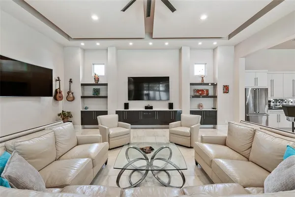 a living room with lots of furniture and a chandelier