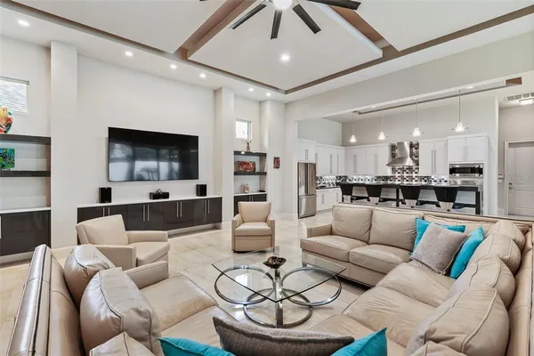 a bedroom with a large bed a flat screen tv and couches